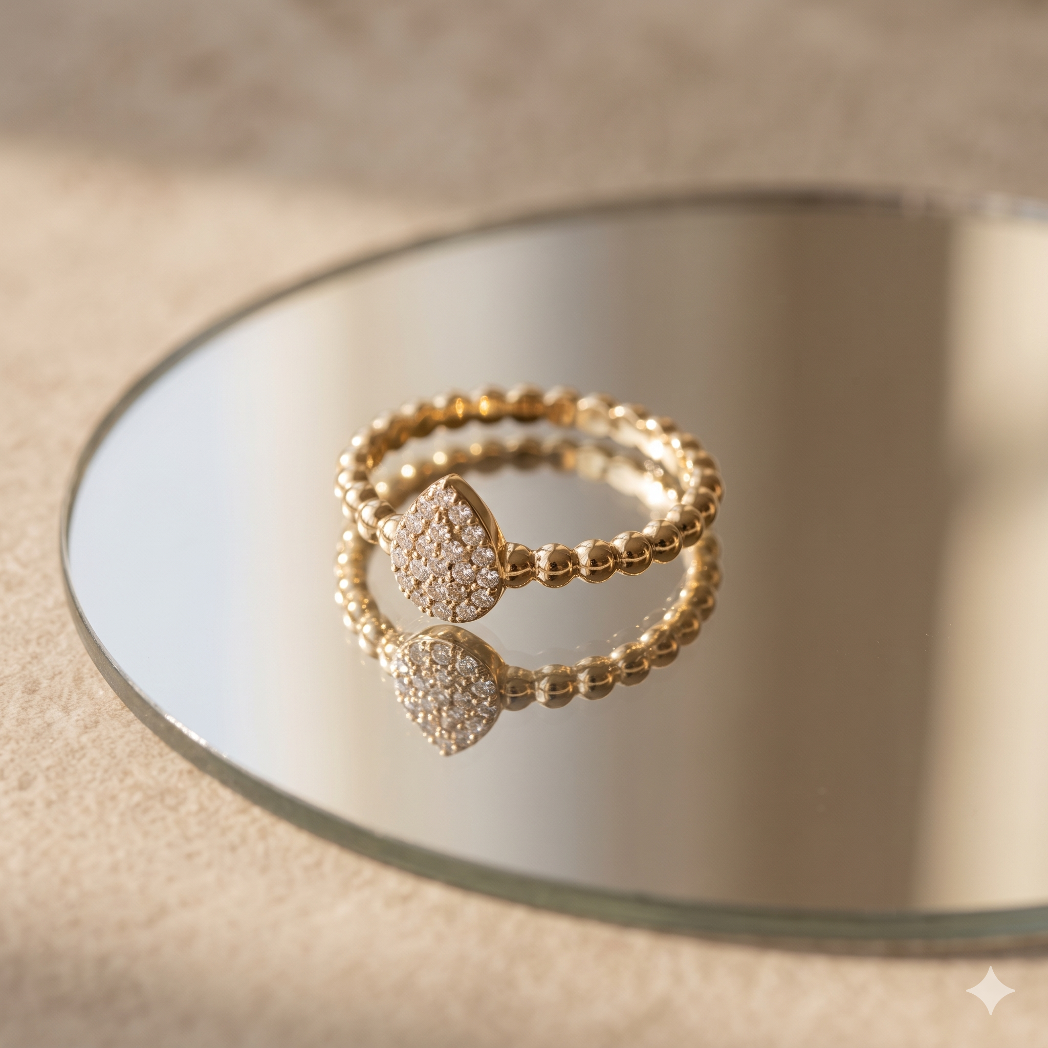 Gold beaded ring with pavŽ teardrop centerpiece